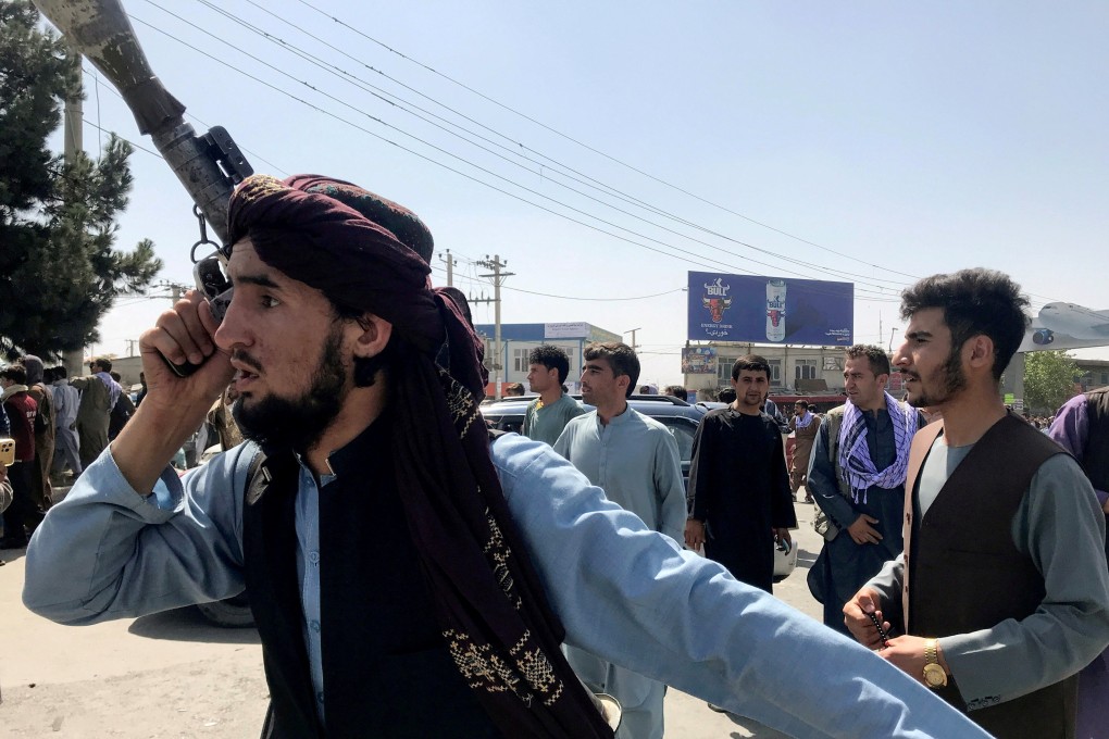 A member of the Taliban forces inspects the area outside Hamid Karzai International Airport in Kabul, Afghanistan on Monday. Photo: Reuters
