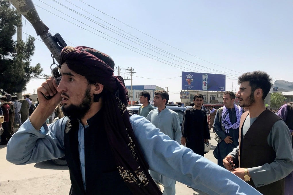 A member of the Taliban forces inspects the area outside Hamid Karzai International Airport in Kabul, Afghanistan on Monday. Photo: Reuters