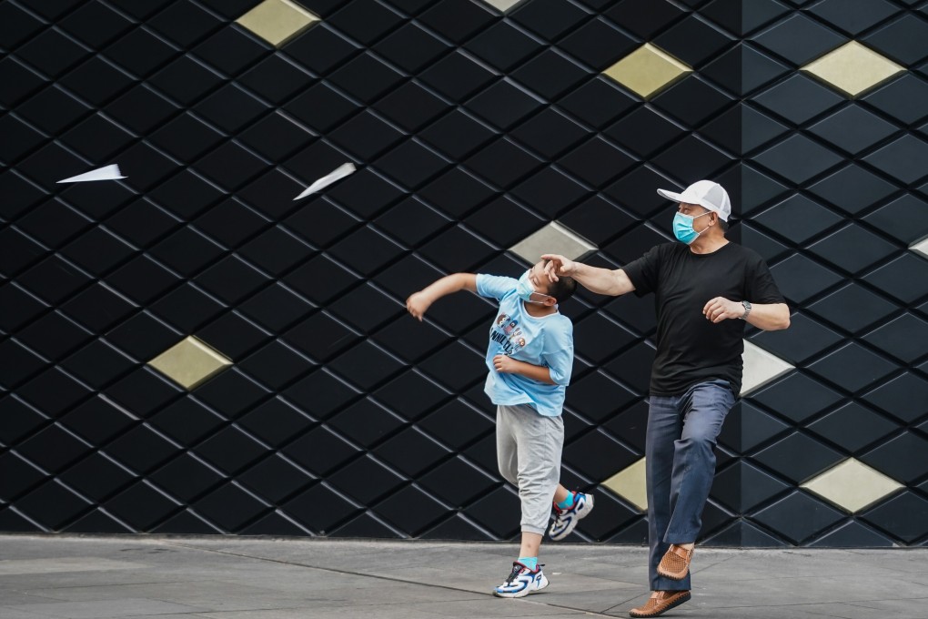 Citizens throw paper planes at a square in Nanjing, as public transport services in the city started to resume. Photo: Xinhua