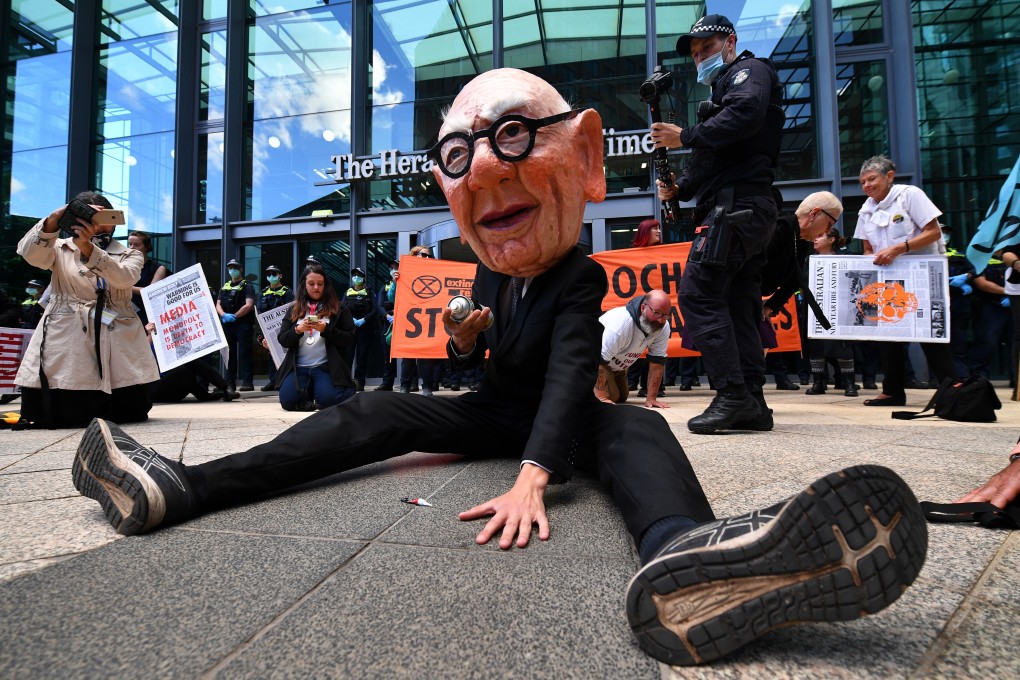 Protesters, including one dressed as Rupert Murdoch, are seen during an Extinction Rebellion environmental protest against News Corporation in Melbourne, Australia, in March. Photo: EPA-EFE