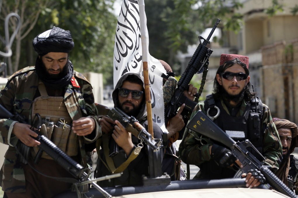 Taliban fighters display their flag while on patrol in Kabul, Afghanistan on Thursday. Photo: AP