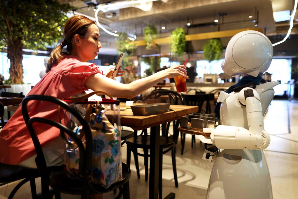 A humanoid robot delivers drinks to customers at the Dawn Cafe in Tokyo. Photo: AFP