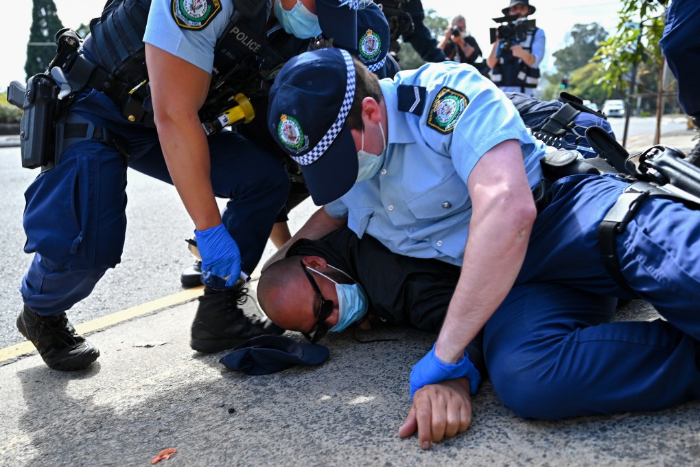 Police tackle a protester during an anti-lockdown protest in Sydney on August 21, 2021. Photo: EPA-EFE