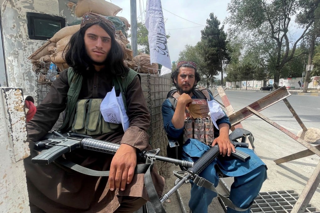 Taliban fighters sit at a checkpoint in Kabul, Afghanistan on Tuesday. Photo: Reuters