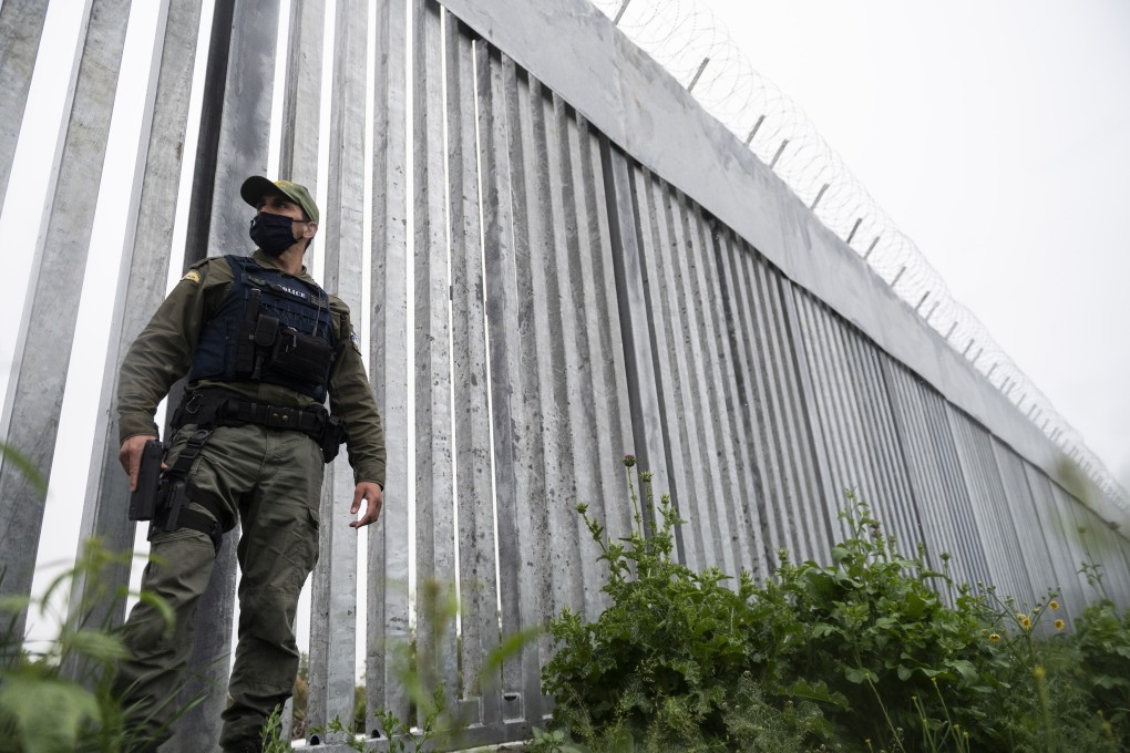 A policeman patrols a steel wall near the village of Poros, at the Greek -Turkish border, in May. Photo: AP