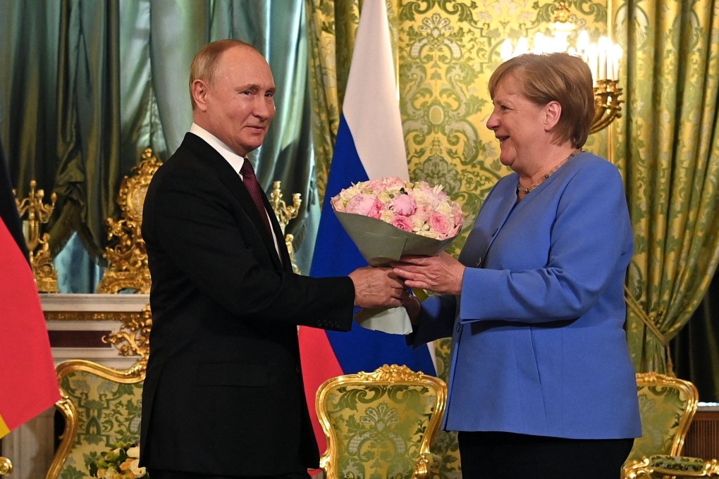 Russian President Vladimir Putin welcomes German Chancellor Angela Merkel at the Kremlin in Moscow on Friday. Photo: Sputnik via AFP