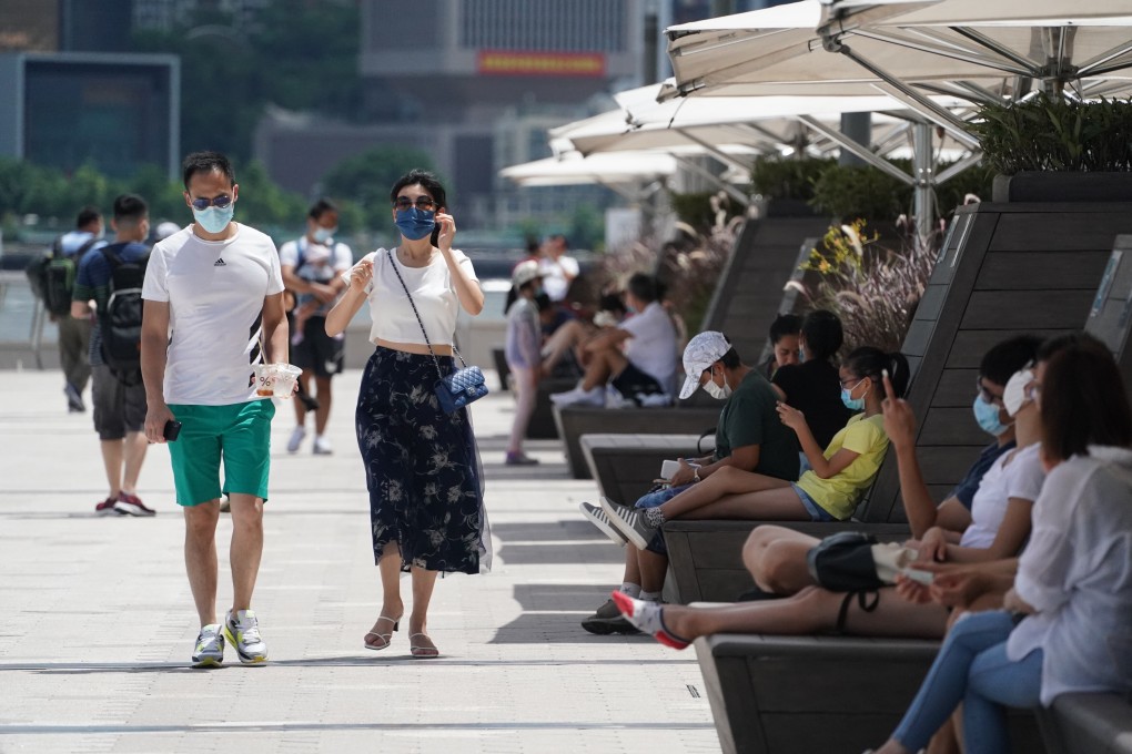 People enjoy the sunshine along the Tsim Sha Tsui waterfront. Hong Kong’s health minister says residents expect authorities to maintain a ‘zero cases’ Covid-19 policy. Photo: Felix Wong