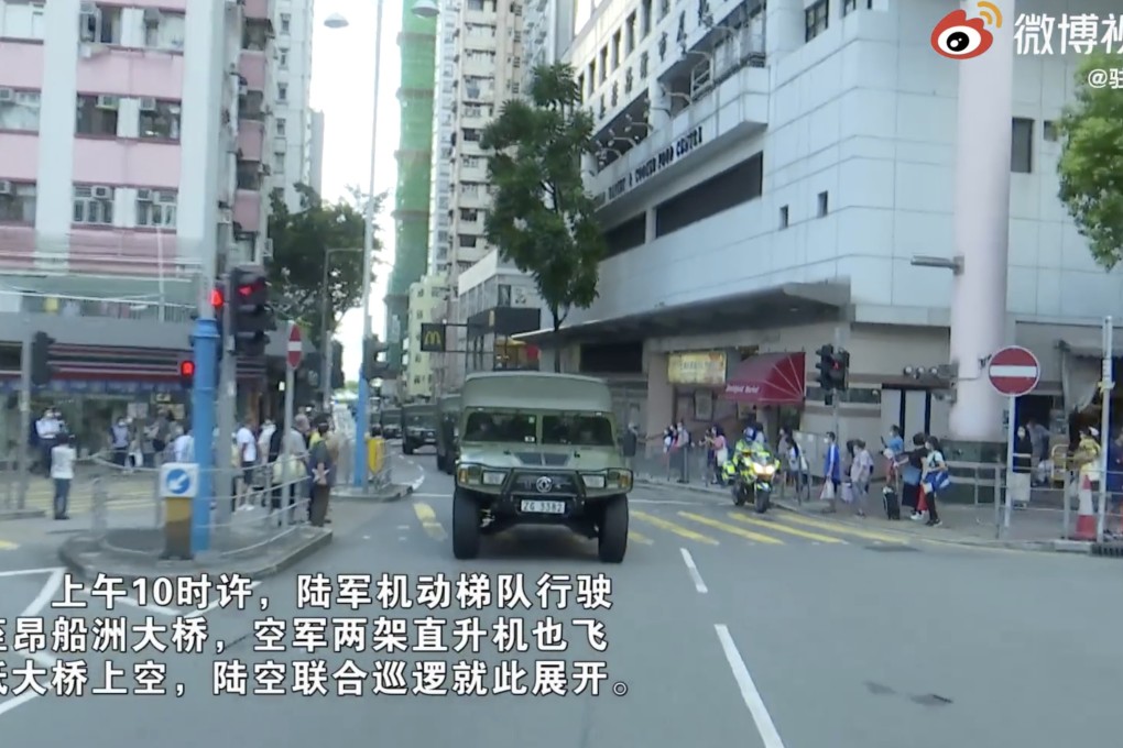 A still from the Weibo video shows a PLA military vehicle cruising down the streets of Hong Kong.