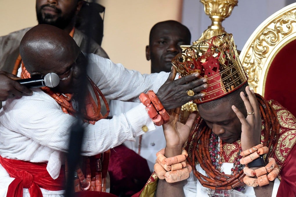 The crown is placed on the head of 37-year-old Prince Omo Oba Utienyinoritsetsola Emiko during his coronation at Ode Itsekiri, Nigeria on Saturday. Photo: AFP