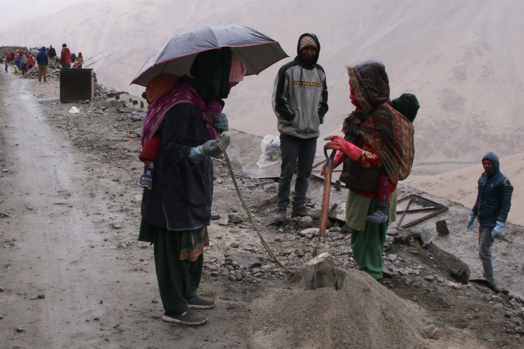 Nepalese construction workers build roads with their babies tied to their backs. Photo: Kamran Yousuf