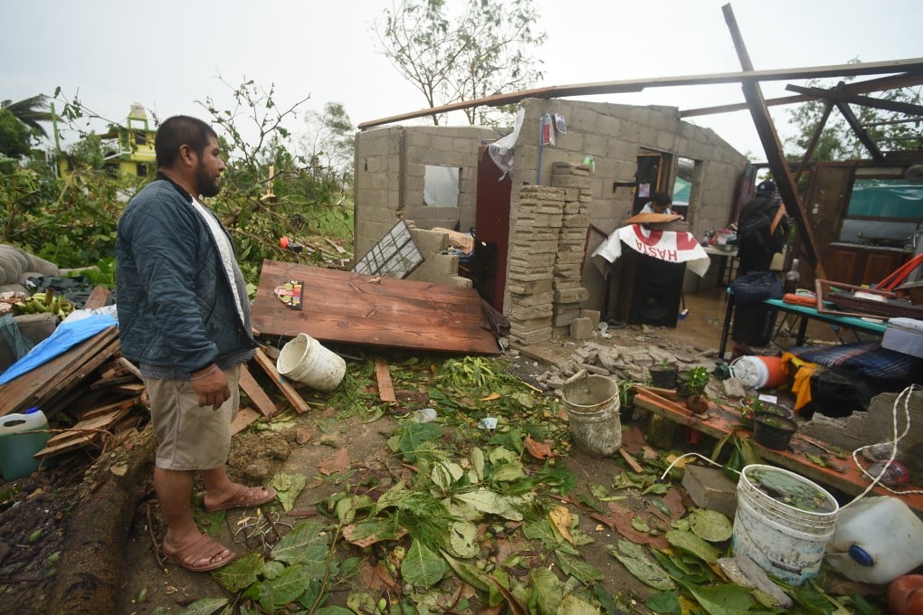 A resident surveys a damaged home in Tecolitla, Veracruz state. Photo: Bloomberg