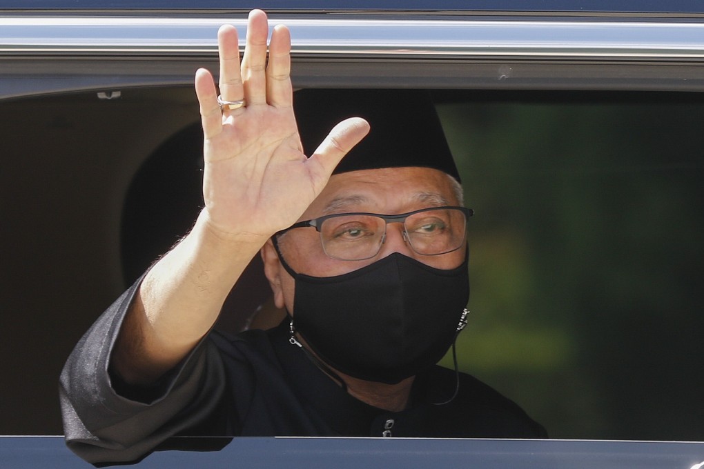 New Malaysian Prime Minister Ismail Sabri Yaakob waves from a vehicle as he leaves the National Palace after his swearing-in ceremony on Saturday. Photo: EPA-EFE