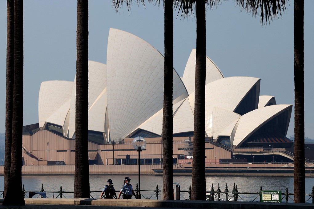 Police officers patrol in front of the Sydney Opera House on August 21, 2021. Photo: AFP