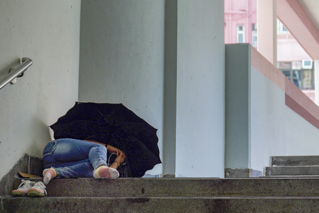 A woman sleeps at a footbridge at Sai Wan Ho. Photo: Sam Tsang