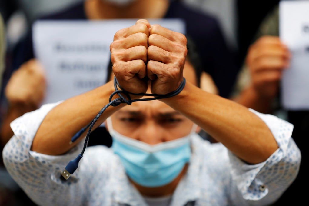 An Afghan refugee binds his hands with cable during a rally asking for justice and resettlement, outside the UN Refugee Agency’s office in Jakarta. Photo: Reuters
