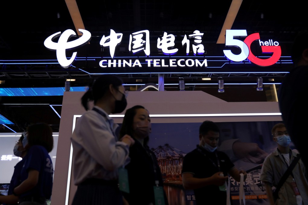 People are seen at a China Telecom booth during the 2021 China Internet Conference in Beijing in July. Photo: Reuters