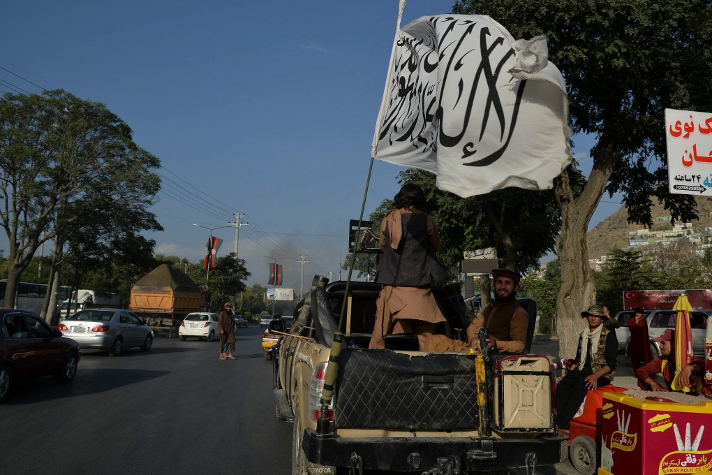 Fighters travel on a vehicle mounted with the Taliban flag in Kabul, after the group’s takeover of Afghanistan. Photo: AFP