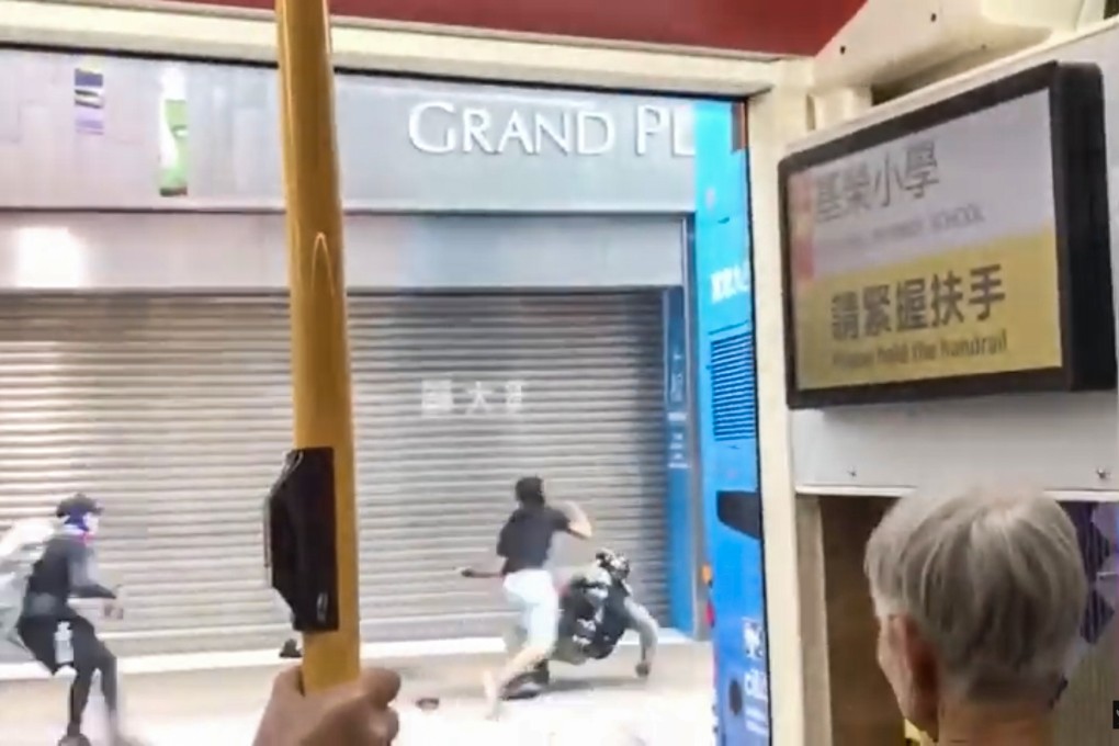 A still from a widely circulated video shows construction worker Tse Shun-shing (blue shorts) attacking a police officer during a protest on October 13, 2019. Photo: Handout