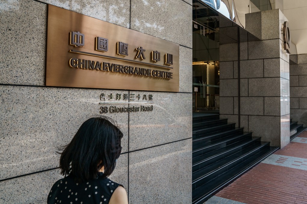 A woman walks past China Evergrande Centre, the Chinese developer’s headquarters in Hong Kong. Photo: Bloomberg