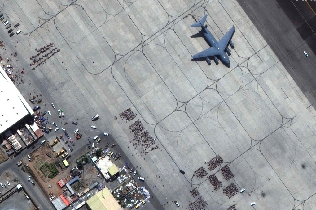 A satellite image shows crowds of people waiting on the tarmac at Kabul’s Hamid Karzai International Airport, with a C-17 transport aircraft ready. Photo: Maxar Technologies