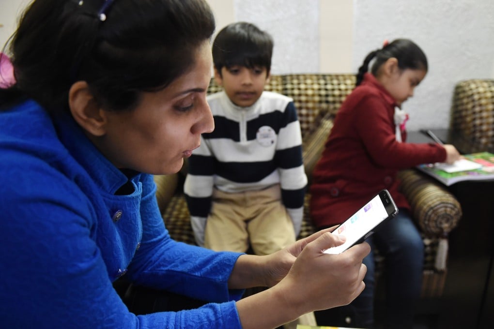 An Indian teacher uses an app that uses ‘gamified’ methods to help children learn. Photo: AFP