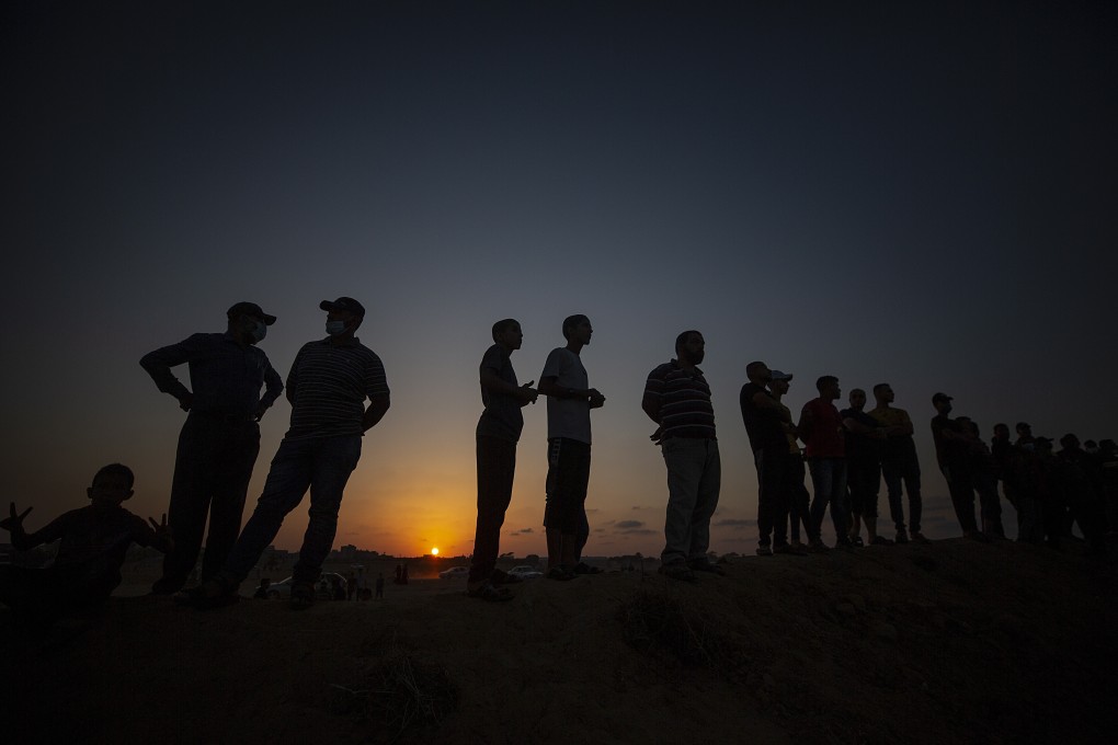 Palestinian protesters gather during the clashes near the border between Israel and the Gaza strip in the town of Khan Younis on Wednesday. Photo: EPA-EFE