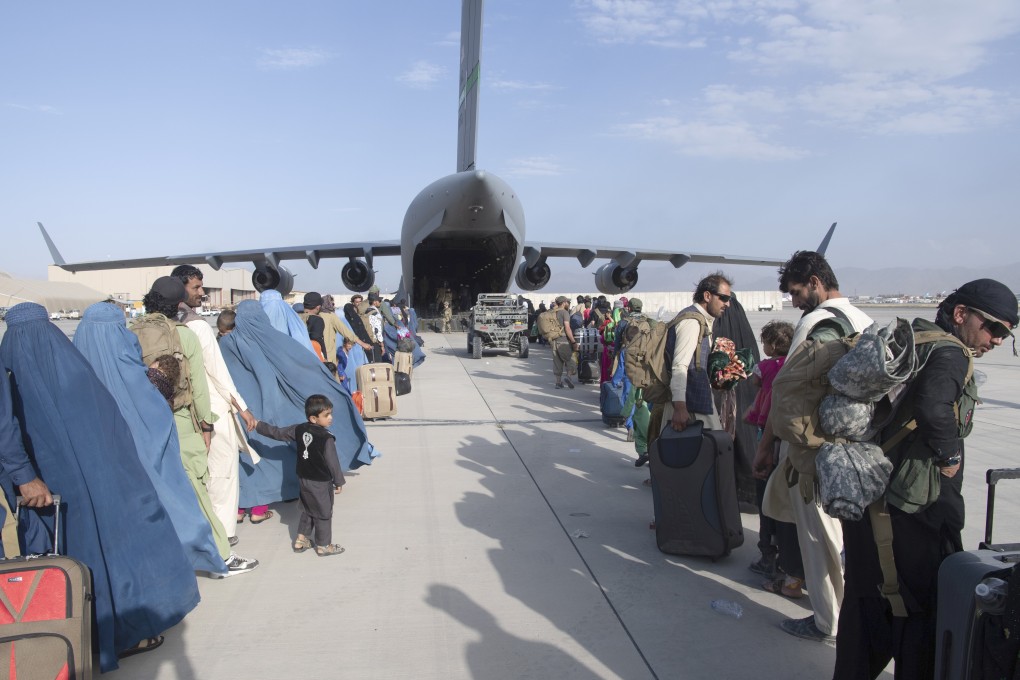 The US Air Force loads people being evacuated from Afghanistan onto a US Air Force C-17 Globemaster III at Hamid Karzai International Airport in Kabul, Afghanistan on Tuesday. Photo: US Air Force via AP