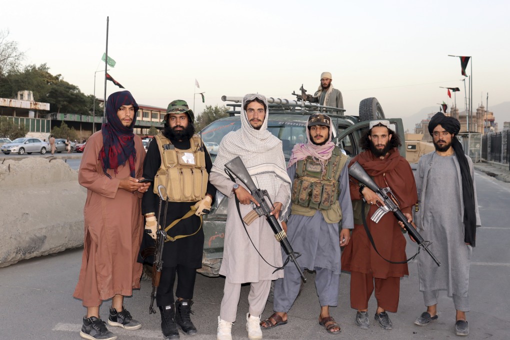 Taliban fighters at a checkpoint on the road in Kabul. Photo: AP