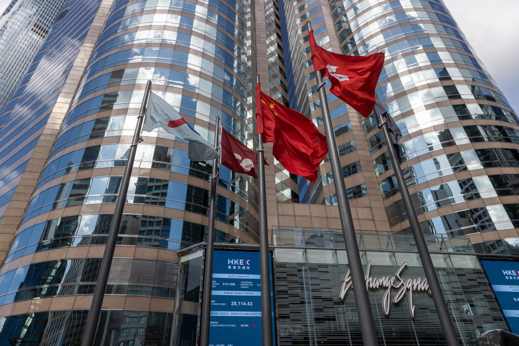 The Chinese and Hong Kong flags fly outside Exchange Square, the building housing the bourse, in Hong Kong. Photo: EPA-EFE