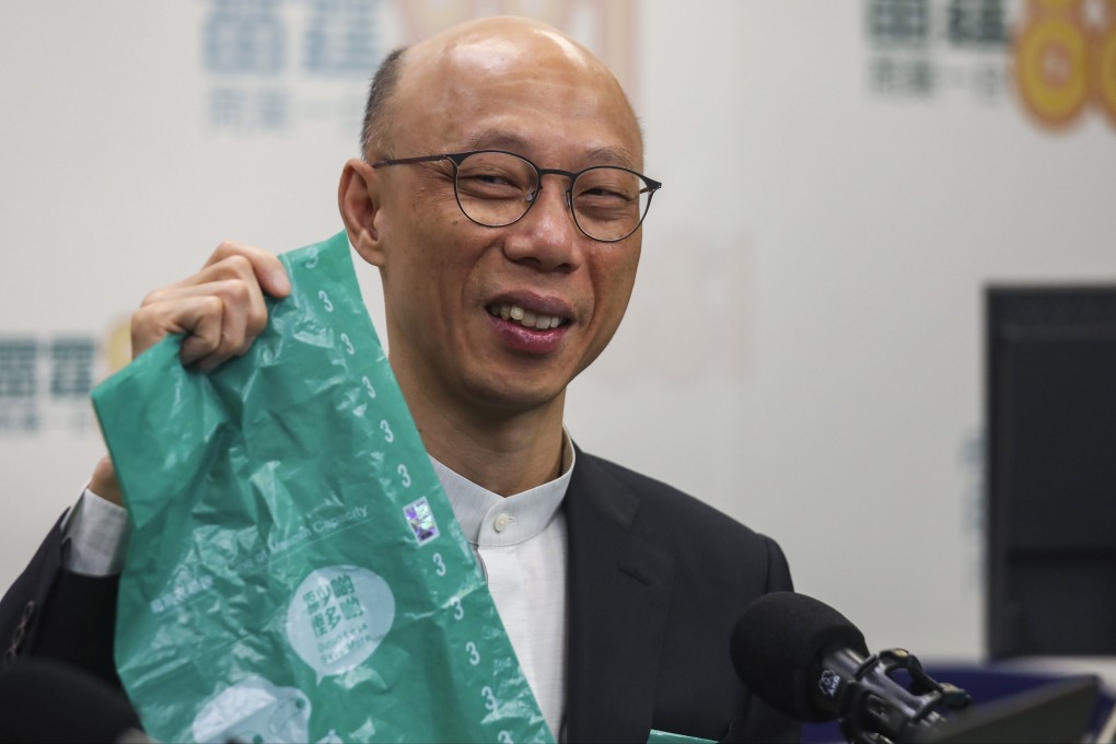 Secretary for the Environment Wong Kam-sing holds up one of the government-made rubbish bags. Photo: Xiaomei Chen