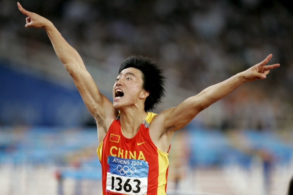 China's Liu Xiang celebrates as he crosses the finish line to win the men's 110 metres hurdle final at the Athens 2004 Olympic Games. Photo: Reuters