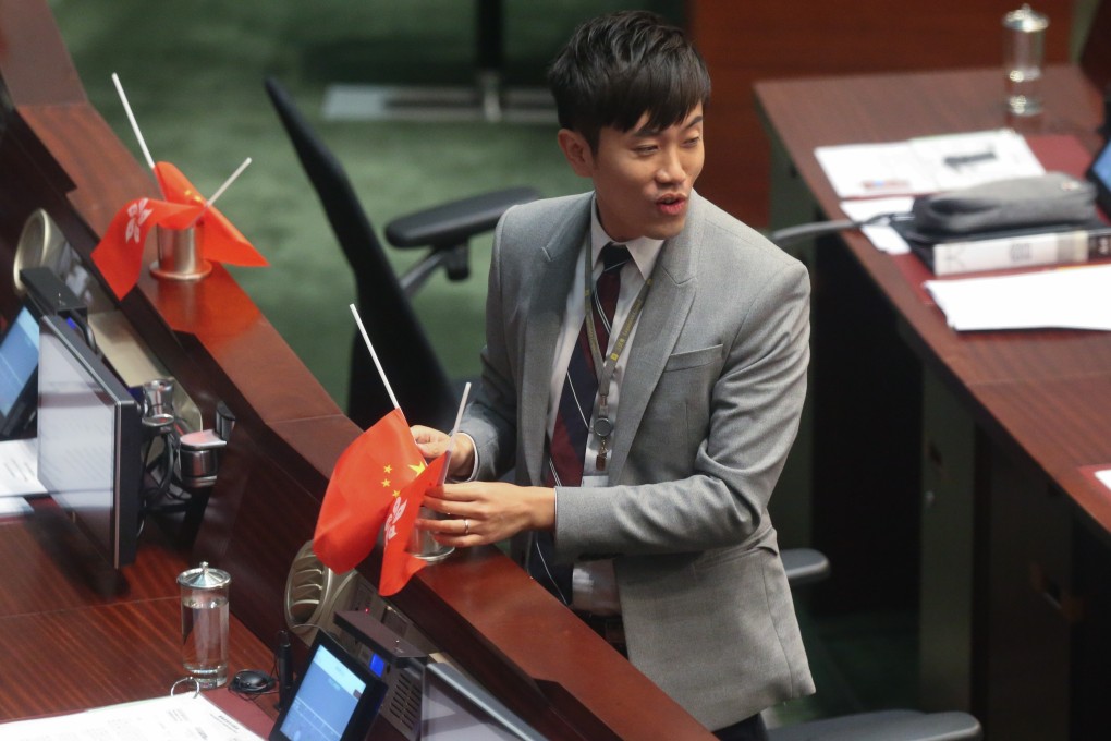 Cheng Chung-tai turns national and Hong Kong flags upside down in the Legislative Council chamber in October 2016. Photo K. Y. Cheng