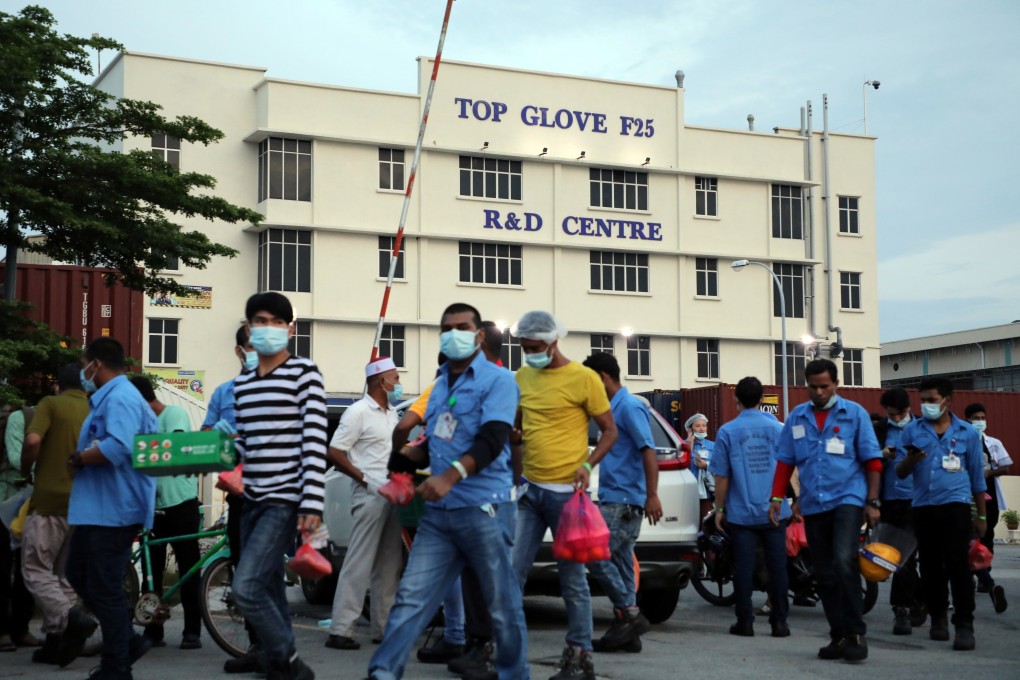 Workers leave a Top Glove factory after their shifts in Klang, Malaysia. Photo: Reuters