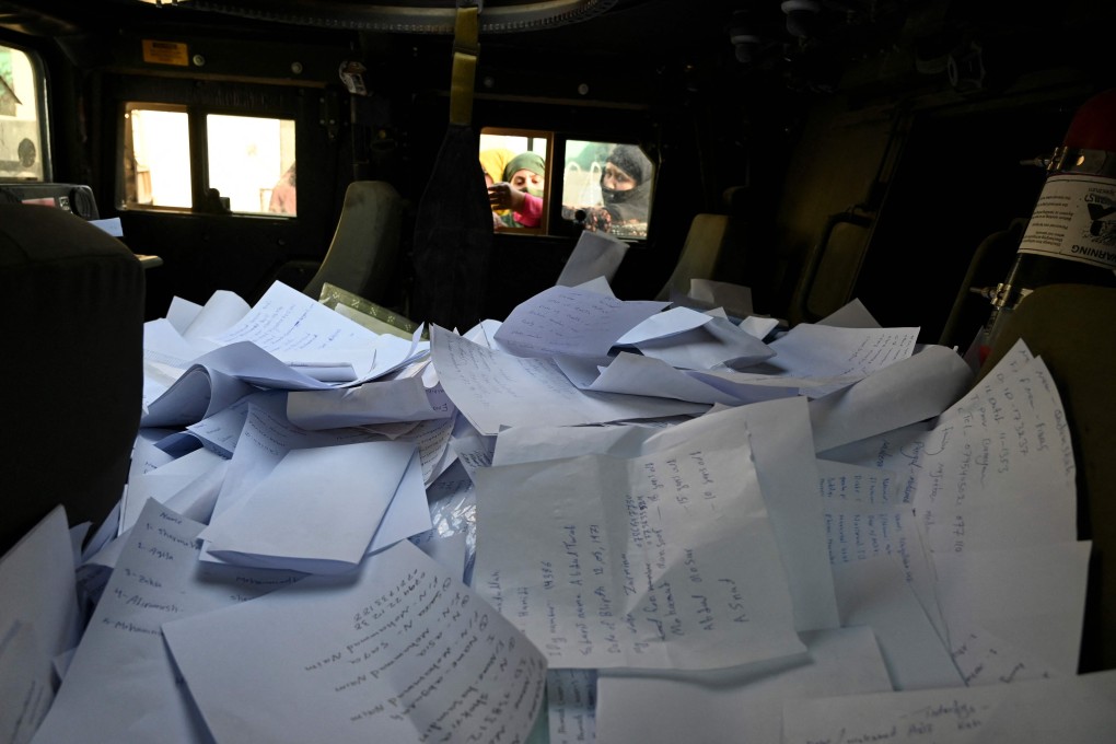 Sheets of paper filled with details of Afghan residents inside a Humvee in front of the British and Canadian embassy in Kabul. Photo: AFP