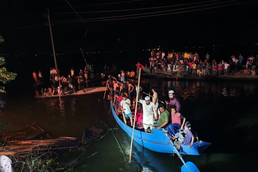 Onlookers gather as rescue operations are conducted to look for the victims of a boat that capsized in Brahmanbaria in eastern Bangladesh on Friday. At least 21 people were killed and dozens remain missing as a boat packed with passengers and a sand-laden cargo ship collided in a lake. Photo: AFP