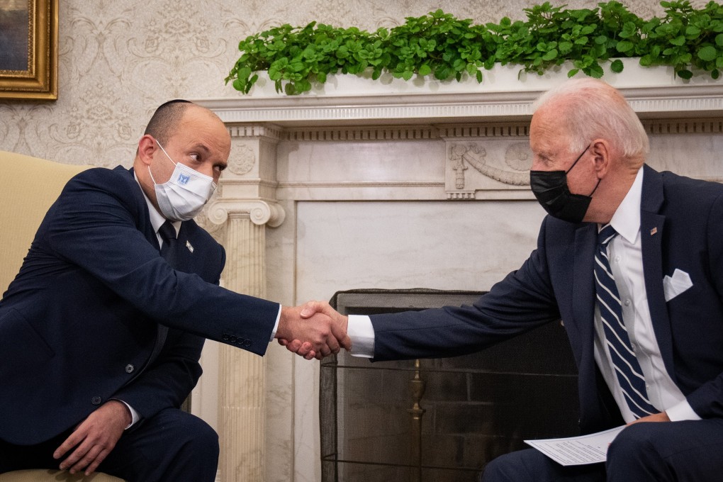 US President Joe Biden, right, and Naftali Bennett, Israel's prime minister, shake hands at their meeting in the Oval Office of the White House on Friday. The two men postponed their meeting after an attack in Afghanistan that killed 13 US service members and at least 75 Afghan citizens. Photo: Bloomberg
