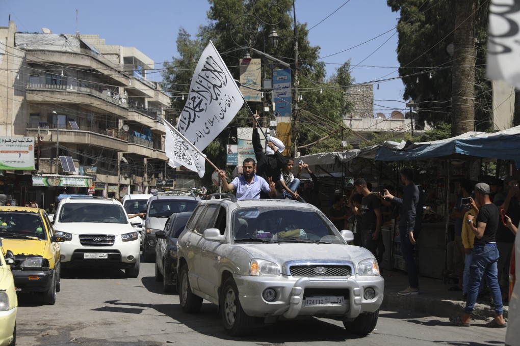 Members of the Hayat Tahrir al-Sham, the al-Qaeda affiliate in the northern Syrian city of Idlib, wave Taliban flags as they celebrate the Taliban’s takeover of Afghanistan on August 20. The takeover of Afghanistan is giving radical Islamic groups from Syria and the Gaza Strip to Pakistan and West Africa reason to celebrate. Photo: AP