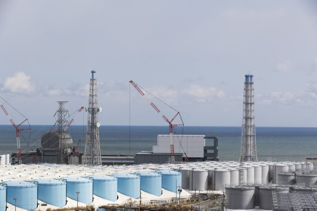 The damaged Fukushima Daiichi nuclear power plant in Japan, and tanks holding radioactive water from it. Photo: AP