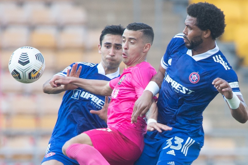 Resources Capital's Felipe Sa (centre) tries to escape the attentions of Eastern defenders Alexander Jojo (left) and Eduardo Praes in the Sapling Cup. Photo: HKFA