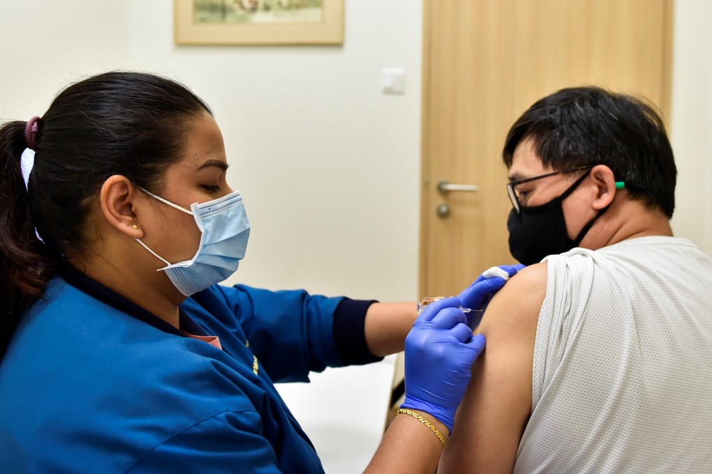 A nurse administers a Covid-19 vaccine in Singapore. Photo: Reuters