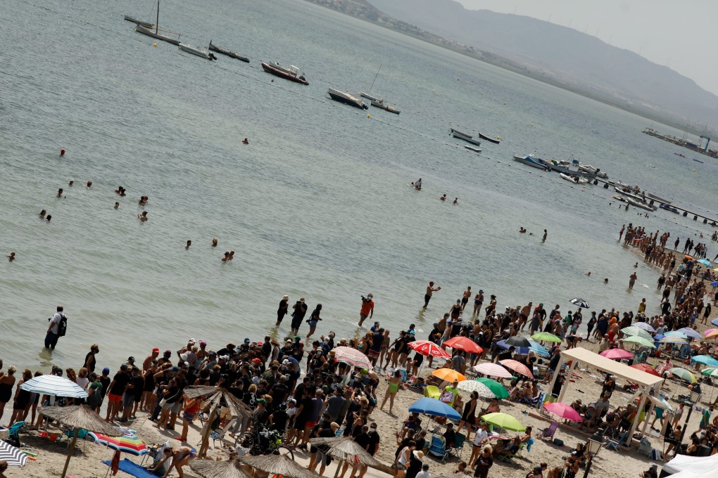 Demonstrators form a human chain around the shore of the Mar Menor lake in Murcia, Spain on Saturday. Photo: Europa Press / DPA