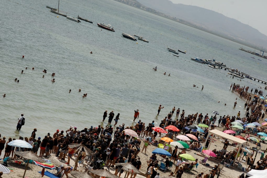 Demonstrators form a human chain around the shore of the Mar Menor lake in Murcia, Spain on Saturday. Photo: Europa Press / DPA