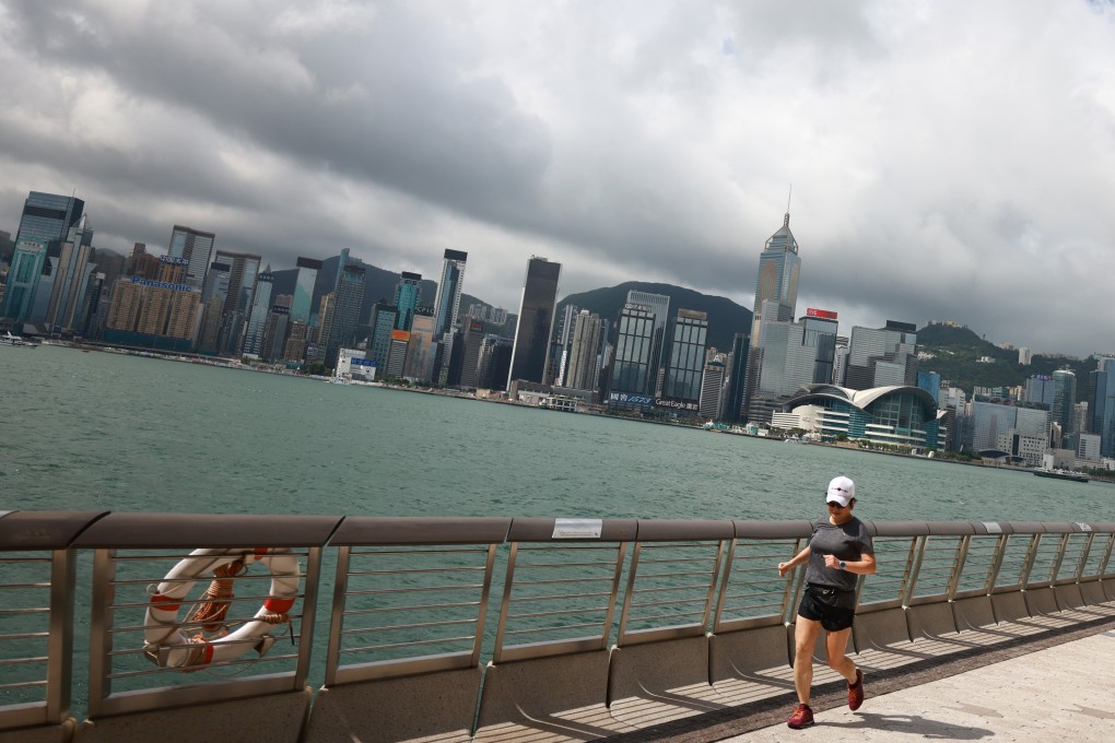 People retain outdoor activities against a gloomy skyline in Tsim Sha Tsui promenade, Tsim Sha Tsui. 30MAY21. SCMP / May Tse
