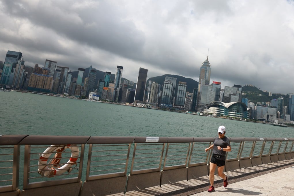 People retain outdoor activities against a gloomy skyline in Tsim Sha Tsui promenade, Tsim Sha Tsui. 30MAY21. SCMP / May Tse