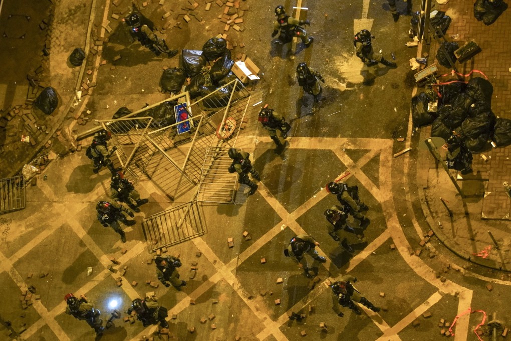 Police clear barricades on Tak Man Street in Hung Hom after clashes with supporters of protesters at Polytechnic University in November 2019. Photo: Roy Issa