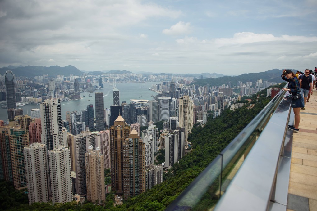 Tourists stand on the viewing platform of Victoria Peak in Hong Kong overlooking the city’s skyline. Photo: Getty Images