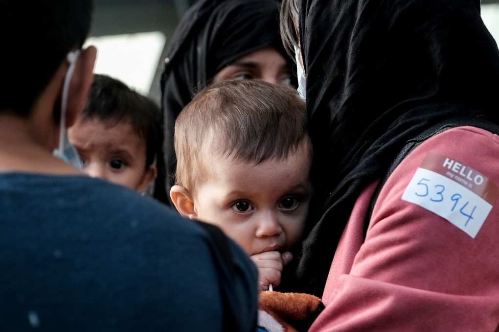 Afghan refugees board a bus taking them to a processing centre upon arrival at Dulles International Airport in the US state of Virginia on Saturday. Photo: Reuters
