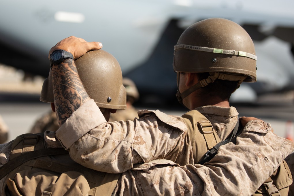 US Marines honour the 11 Marines who were killed during operations in Afghanistan before being airlifted to the US on Monday. Photo: US Marines via Zuma Press / DPA