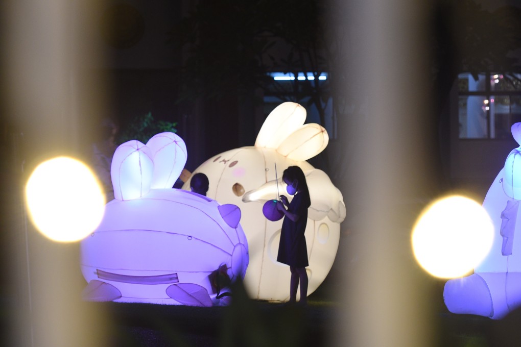 Children wearing face masks play around jade rabbit lantern installations in Singapore on Monday, the seventh consecutive day of more than 100 locally transmitted Covid-19 infections in the city state. Photo: Xinhua