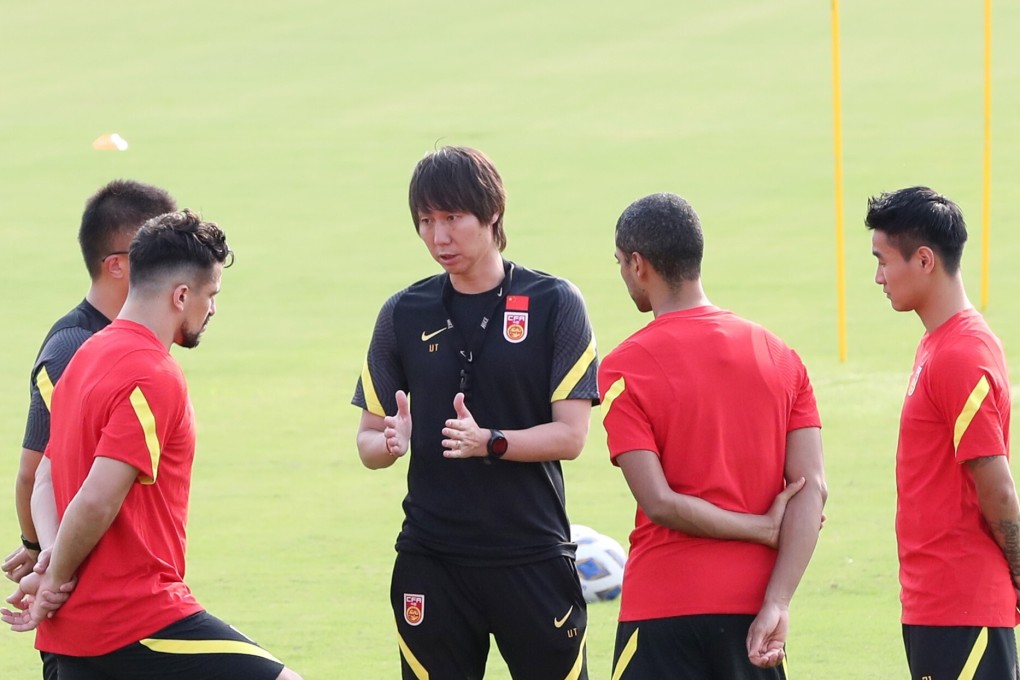 Li Tie (centre), head coach of Chinese national team, gives instructions during a training session in Shanghai. Photo: Xinhua